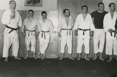 860676 Afbeelding van de Utrechtse judoka Anton Geesink (links), die met leden van zijn sportschool een ...